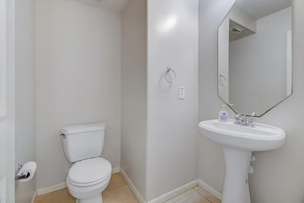 a bathroom with a sink toilet and a mirror