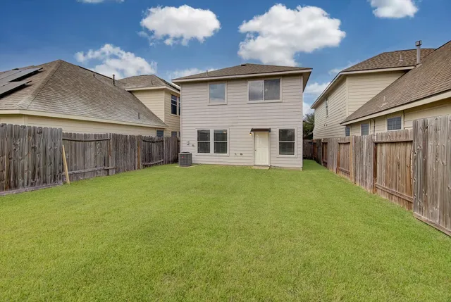 a view of a house with a backyard
