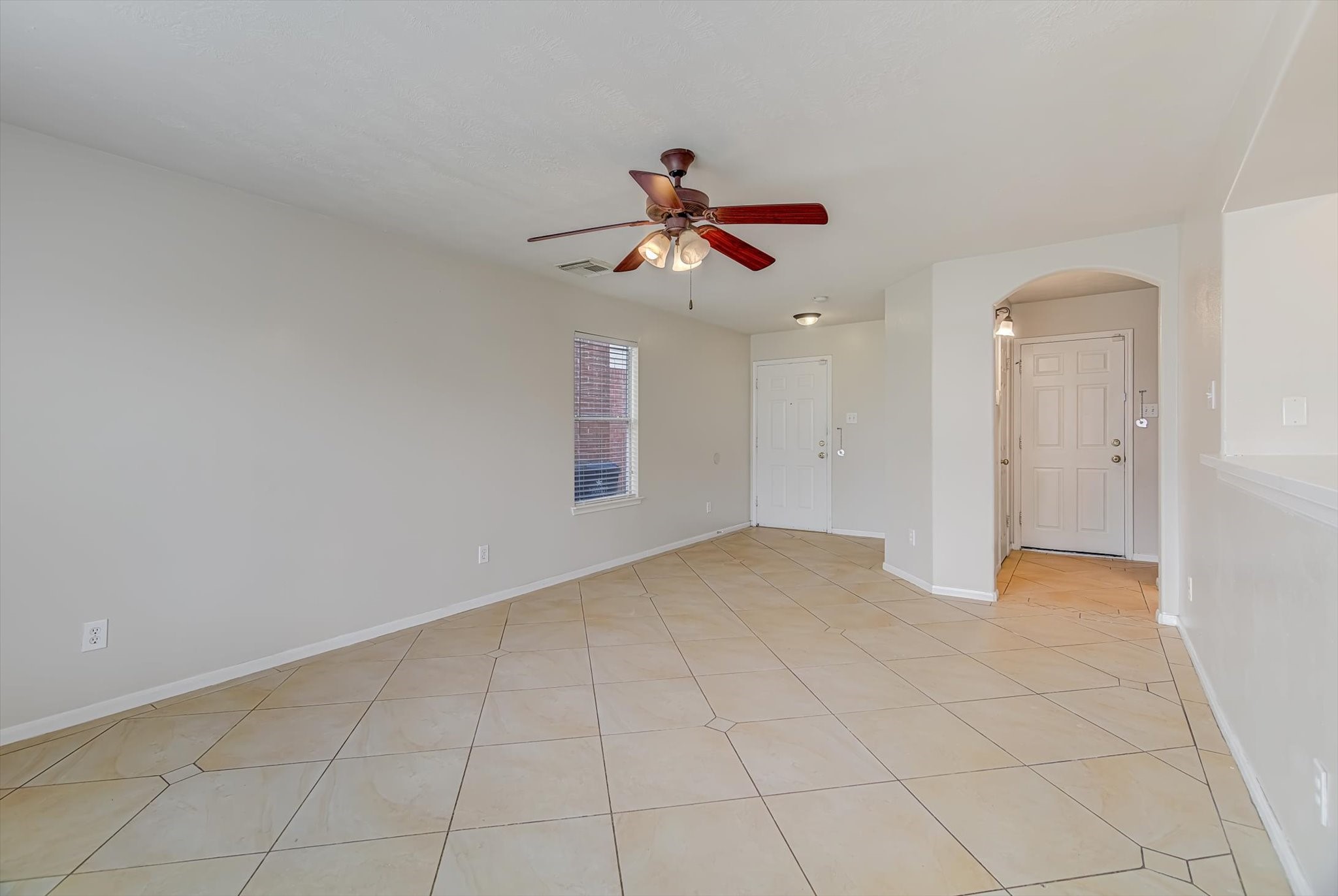 13983 Maximos Drive Houston, TX 77083 - Photo 7 of 34 a view of a livingroom with a chandelier fan and windows