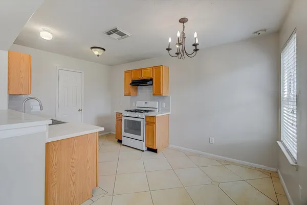 a kitchen that has a sink and a stove top oven