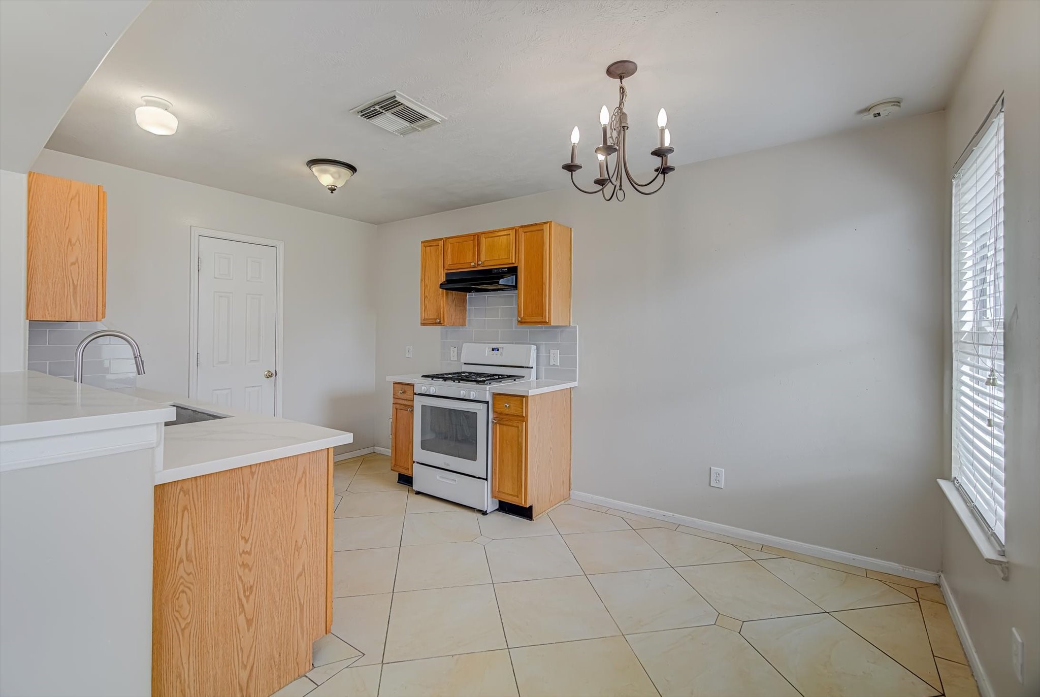 13983 Maximos Drive Houston, TX 77083 - Photo 8 of 34 a kitchen that has a sink and a stove top oven