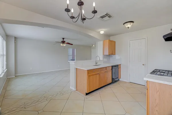 a large kitchen with stainless steel appliances granite countertop a stove a sink and dishwasher