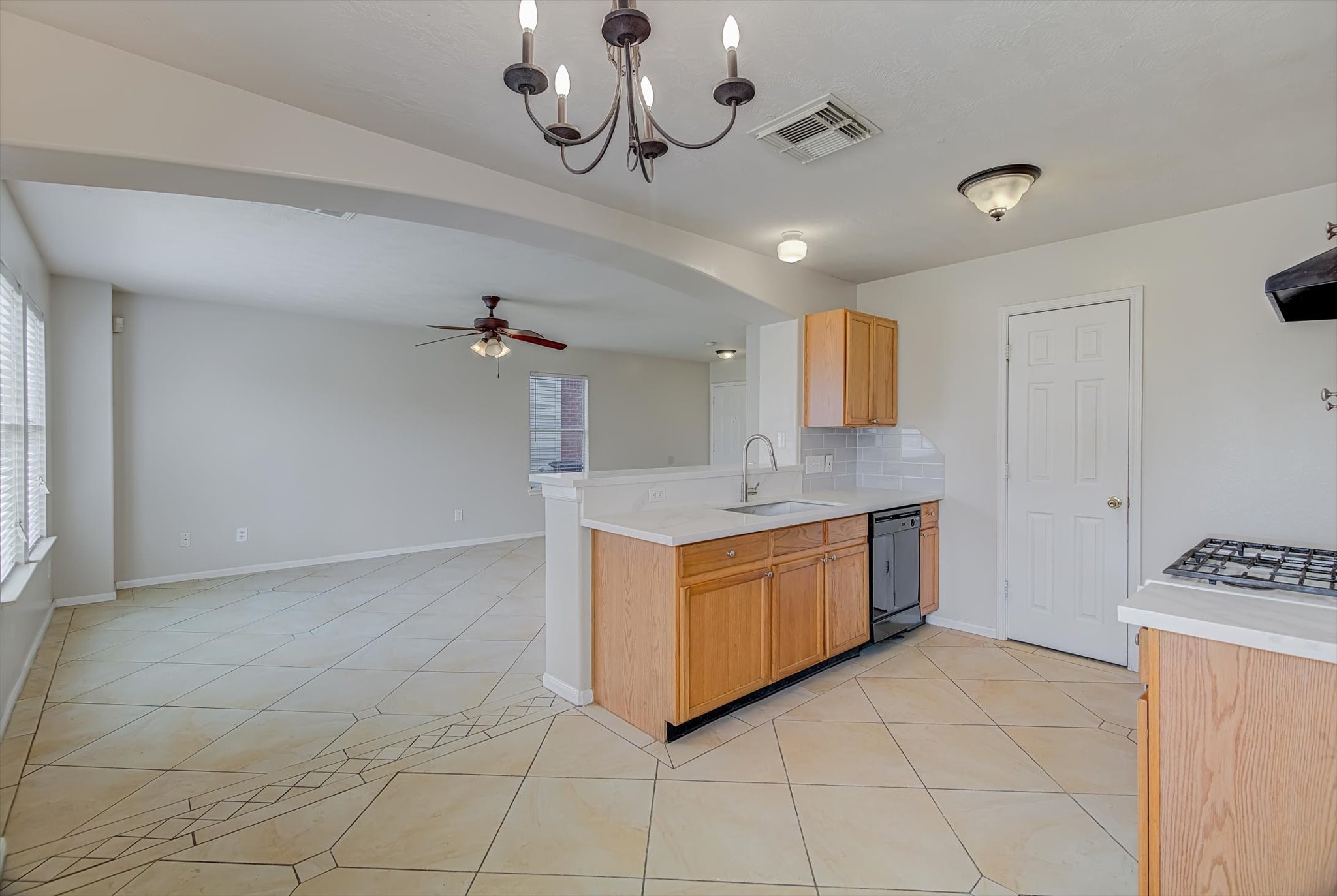 13983 Maximos Drive Houston, TX 77083 - Photo 9 of 34 a large kitchen with stainless steel appliances granite countertop a stove a sink and dishwasher