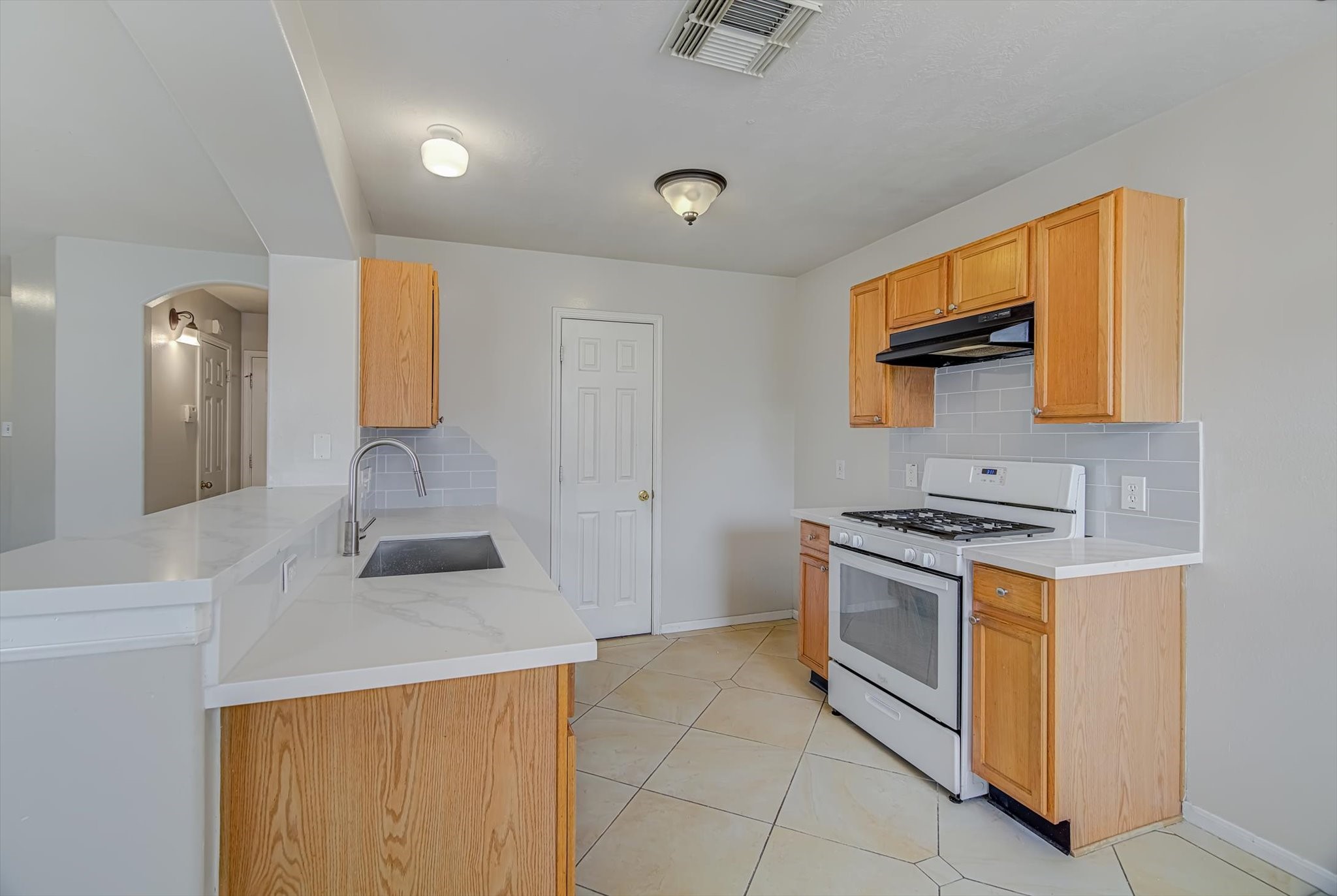 13983 Maximos Drive Houston, TX 77083 - Photo 10 of 34 a kitchen with stainless steel appliances granite countertop a sink and a stove top oven