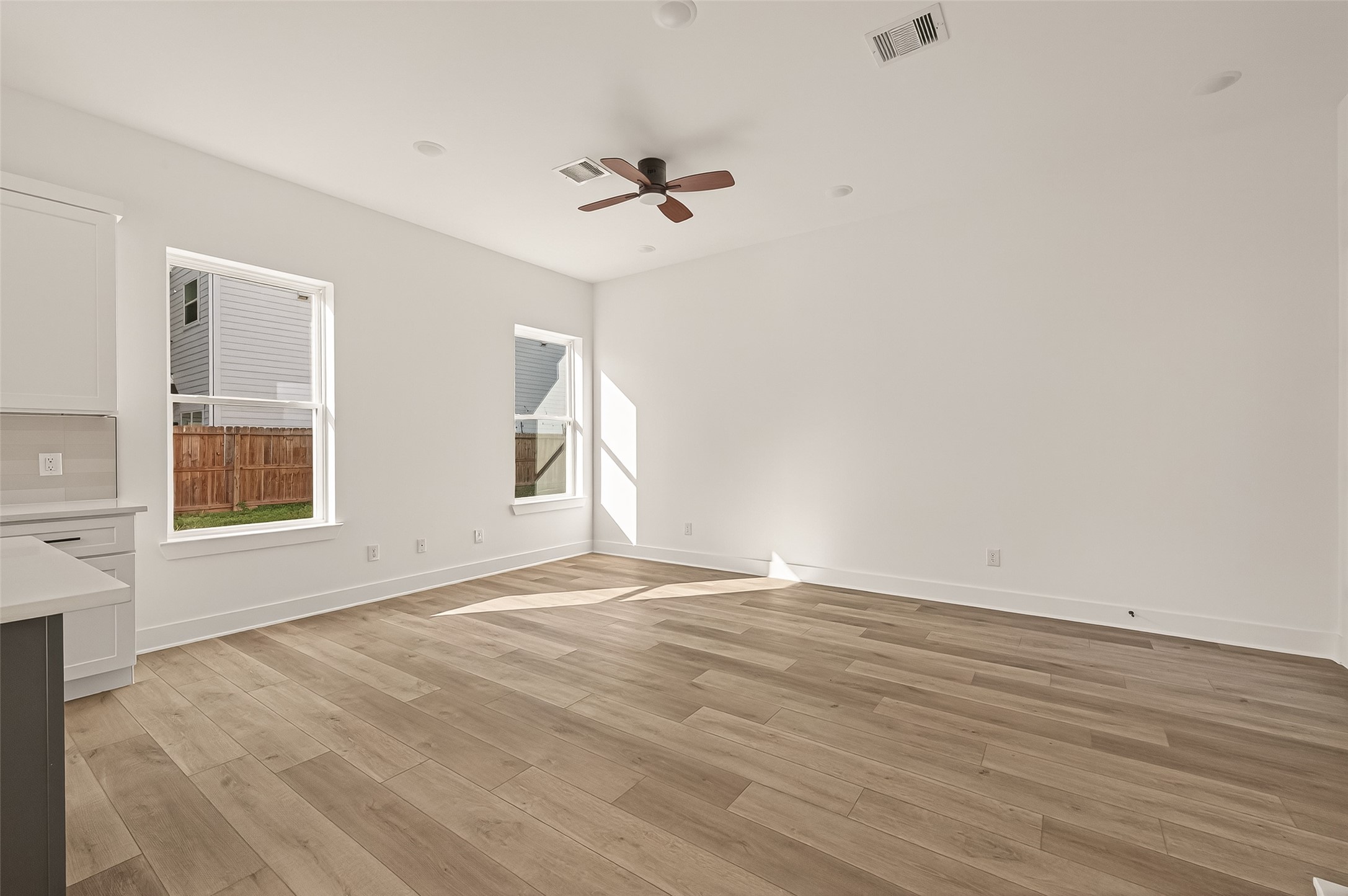 2475 Carmel Street, Unit B Houston, TX 77091 - Photo 5 of 21 Bright open living area with vinyl plank flooring and a clean, modern feel.