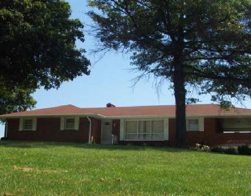 1290 Mill Iron Road Goodview, VA 24095 - Photo 1 of 1 a view of a yard in front of a house with large tree