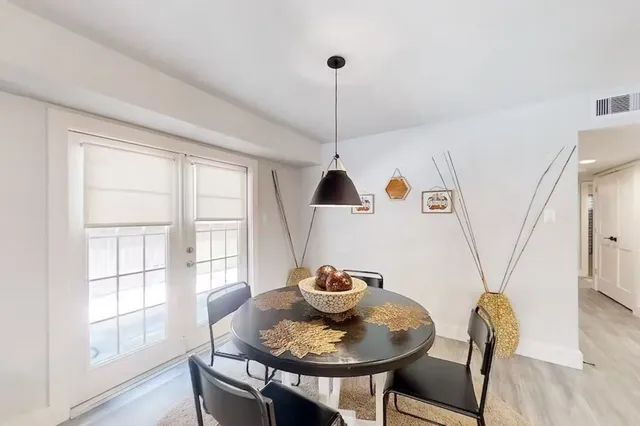 a dining room with furniture and window
