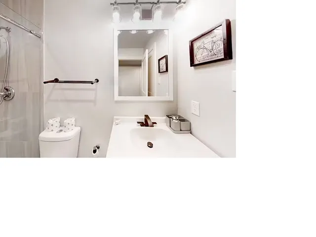 a bathroom with a tub sink and mirror
