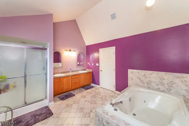 a bathroom with a bathtub sink and glass door