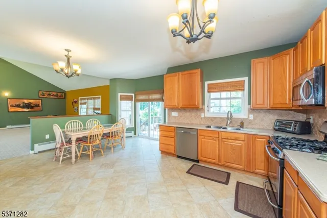 a large kitchen with a table and chairs in it