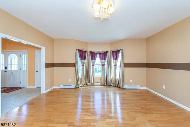 a view of a room with wooden floor
