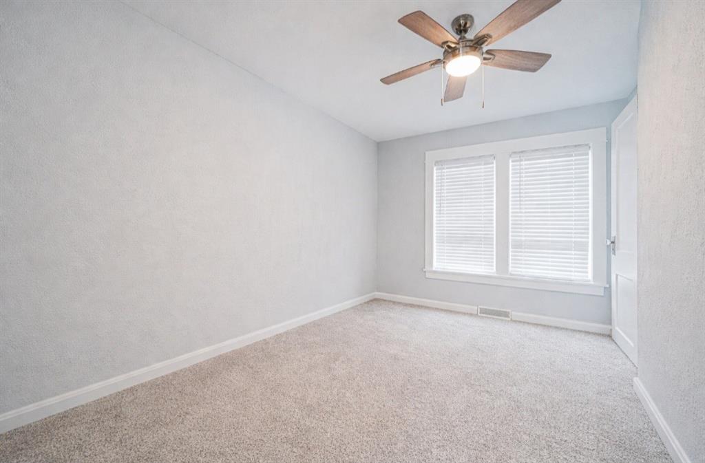 671 Old Rte 8 Harrisville, PA 16038 - Photo 25 of 49 an empty room with a window and a fan