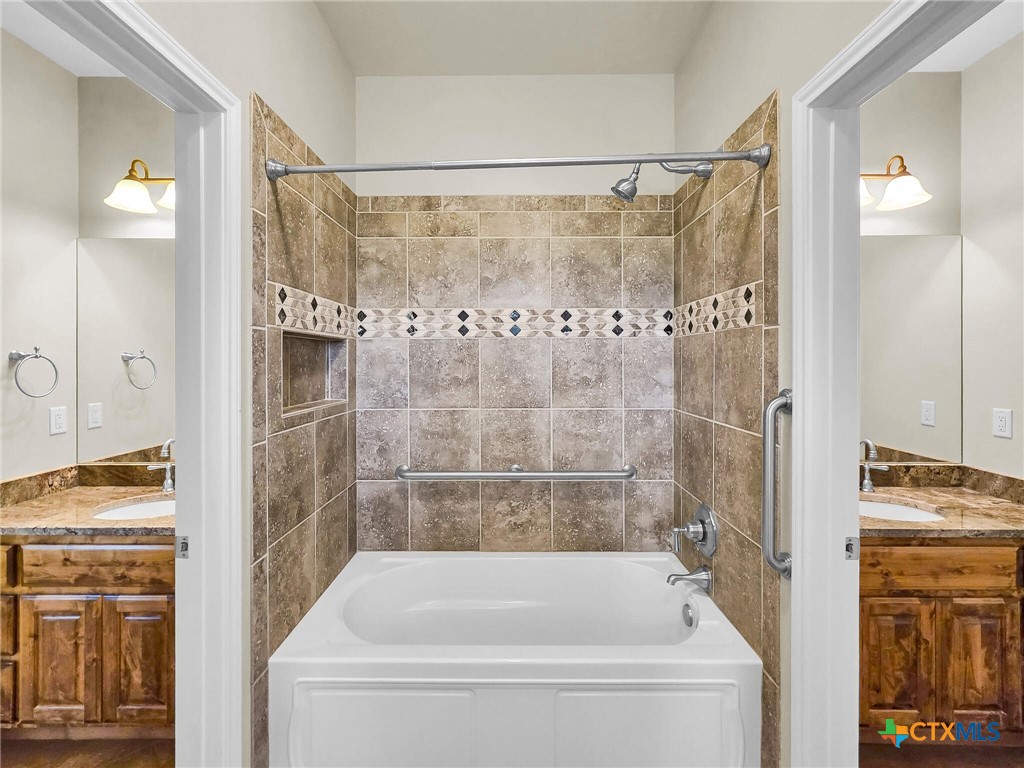 301 County Road 253 Bertram, TX 78605 - Photo 17 of 28 a bathroom with a bathtub and a shower
