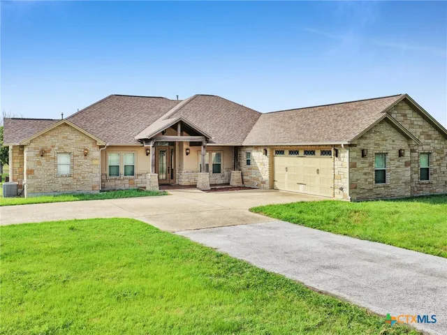 a house with huge green field in front of it