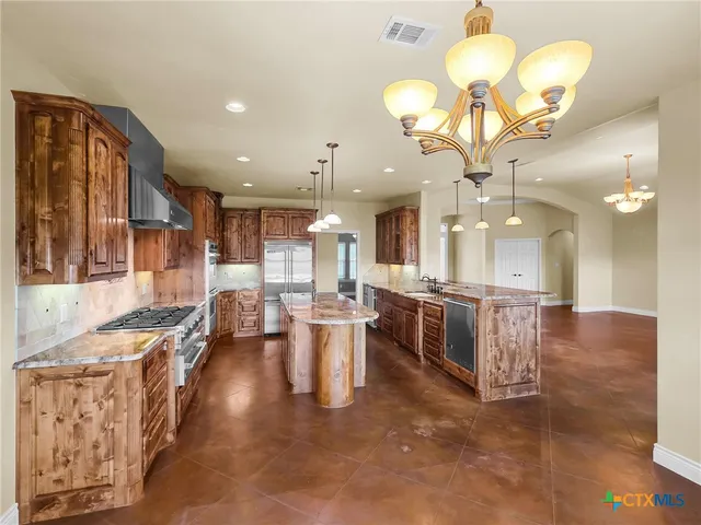 a large kitchen with a table and chairs