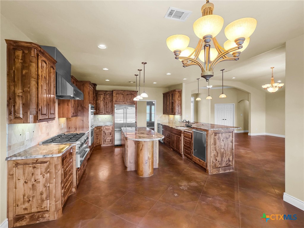 301 County Road 253 Bertram, TX 78605 - Photo 5 of 28 a large kitchen with a table and chairs