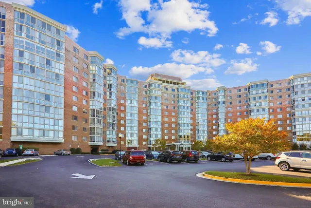 a sign board with buildings in the background