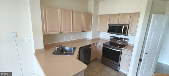a kitchen with a sink cabinets and toilet