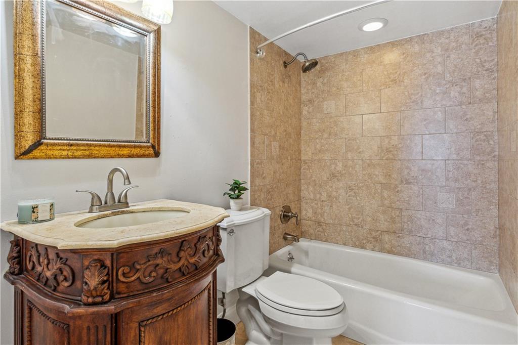 320 South Surf Road, Unit 601 Hollywood, FL 33019 - Photo 13 of 19 a bathroom with a sink a toilet and a mirror