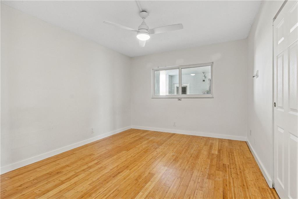 320 South Surf Road, Unit 601 Hollywood, FL 33019 - Photo 14 of 19 an empty room with wooden floor and windows