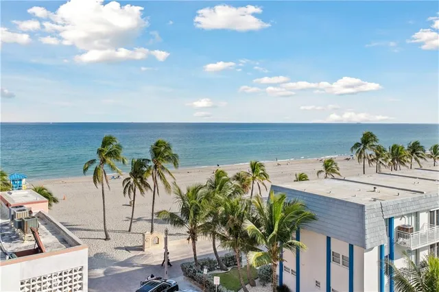 a view of a palm tree from a balcony