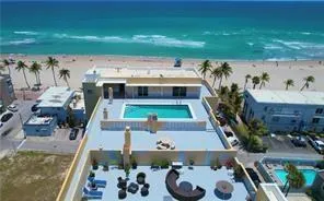 an aerial view of a swimming pool with outdoor seating
