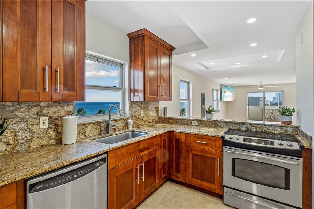 320 South Surf Road, Unit 601 Hollywood, FL 33019 - Photo 5 of 19 a kitchen with stainless steel appliances granite countertop a sink stove and cabinets