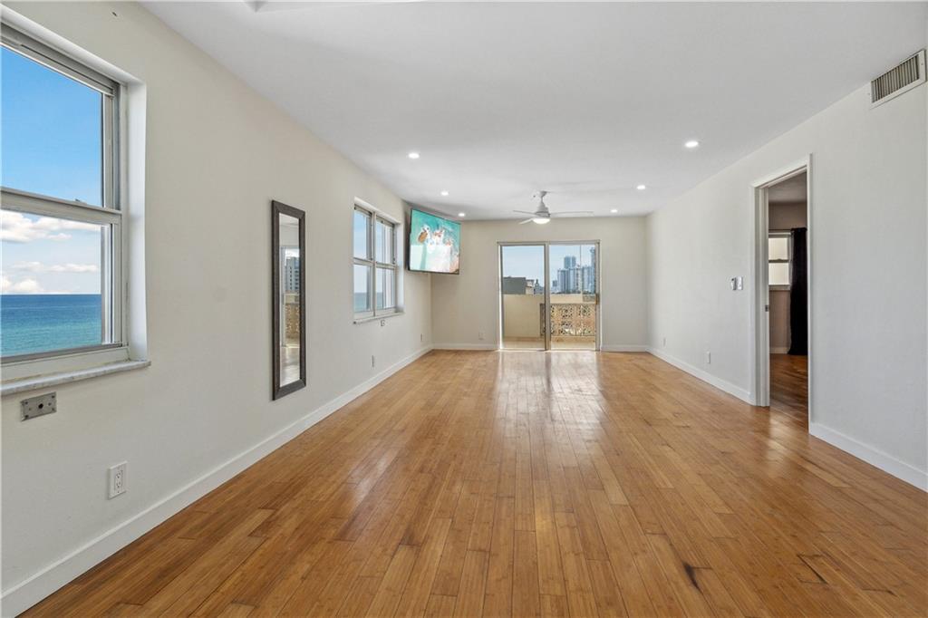 320 South Surf Road, Unit 601 Hollywood, FL 33019 - Photo 7 of 19 a view of an empty room with wooden floor and a window