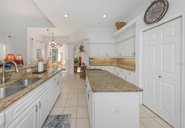 a dining room with furniture a chandelier and wooden floor