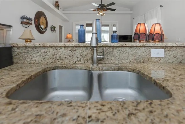 a living room with furniture a large window and a rug