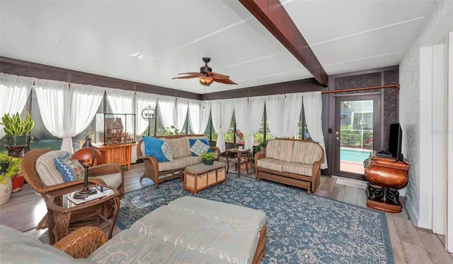 a view of a dining room with furniture and a chandelier