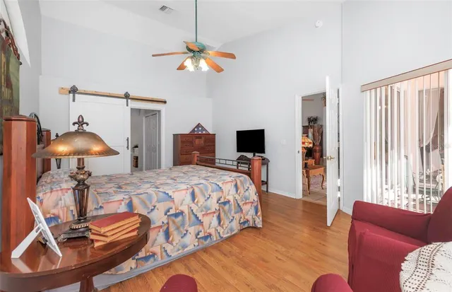an aerial view of residential house with outdoor space and trees all around