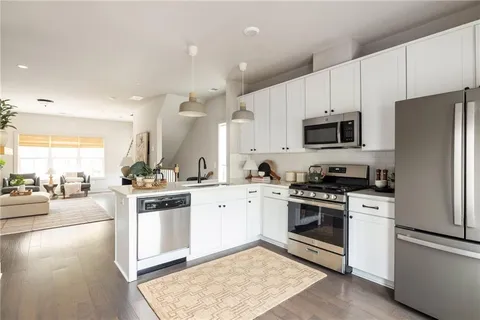 a kitchen with a stove a sink and a refrigerator