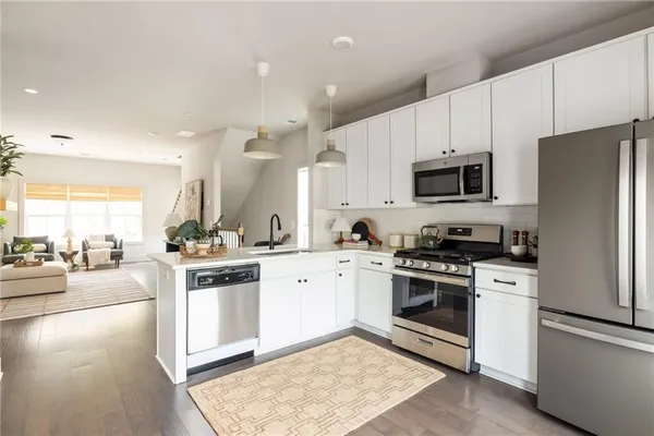 a kitchen with a stove a sink and a refrigerator