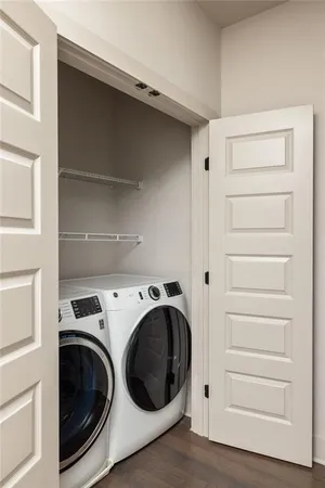 a utility room with washing machine and a view of bedroom