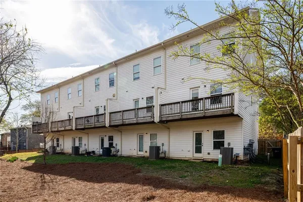 a view of a white building with large windows