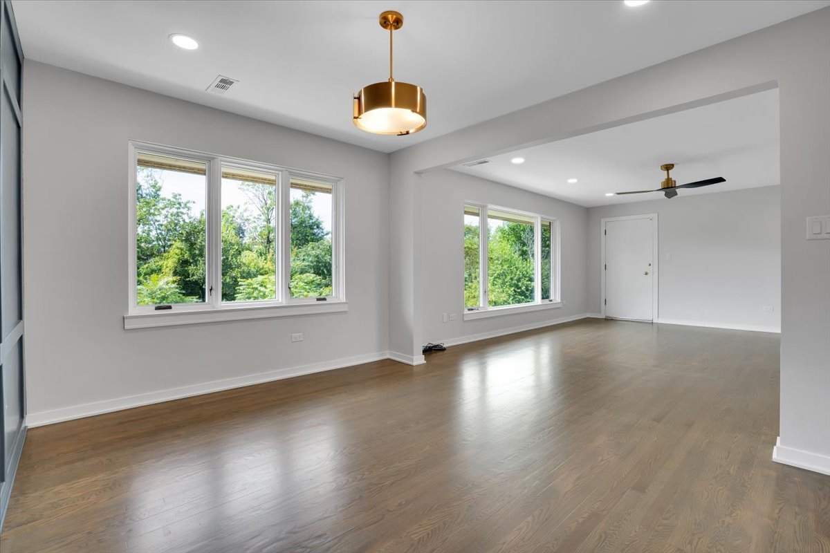 7330 Ogden Avenue, Unit 3 Riverside, IL 60546 - Photo 12 of 37 an empty room with wooden floor and windows