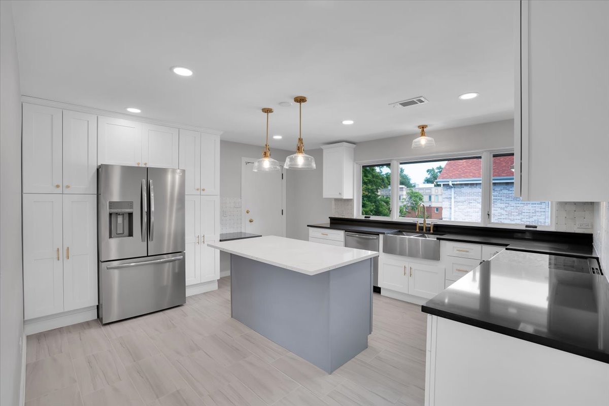 7330 Ogden Avenue, Unit 3 Riverside, IL 60546 - Photo 13 of 37 a large kitchen with stainless steel appliances kitchen island a large counter top a sink and a refrigerator