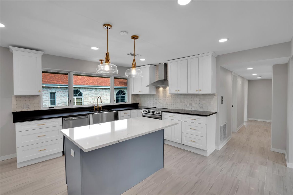 7330 Ogden Avenue, Unit 3 Riverside, IL 60546 - Photo 14 of 37 a large kitchen with kitchen island a sink a center island stainless steel appliances and a counter space