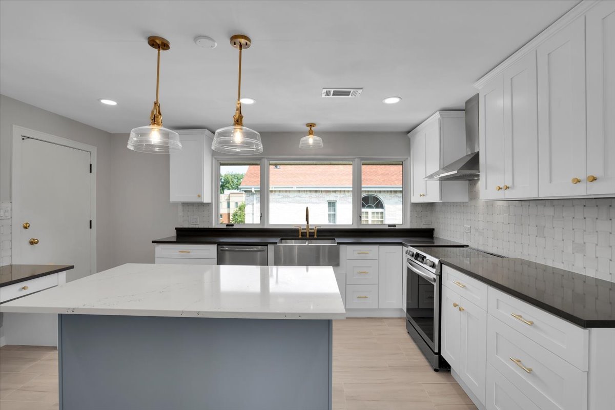 7330 Ogden Avenue, Unit 3 Riverside, IL 60546 - Photo 16 of 37 a kitchen with stainless steel appliances a sink a stove a center island and cabinets