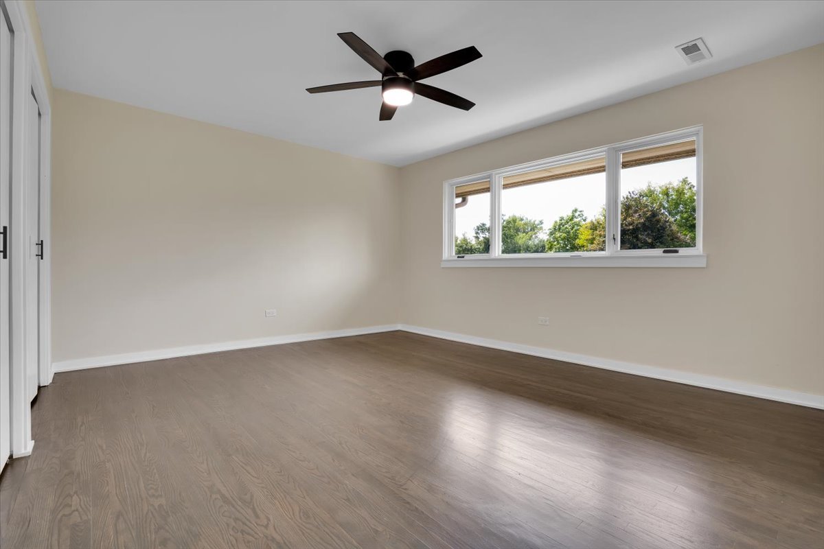 7330 Ogden Avenue, Unit 3 Riverside, IL 60546 - Photo 18 of 37 an empty room with wooden floor and windows