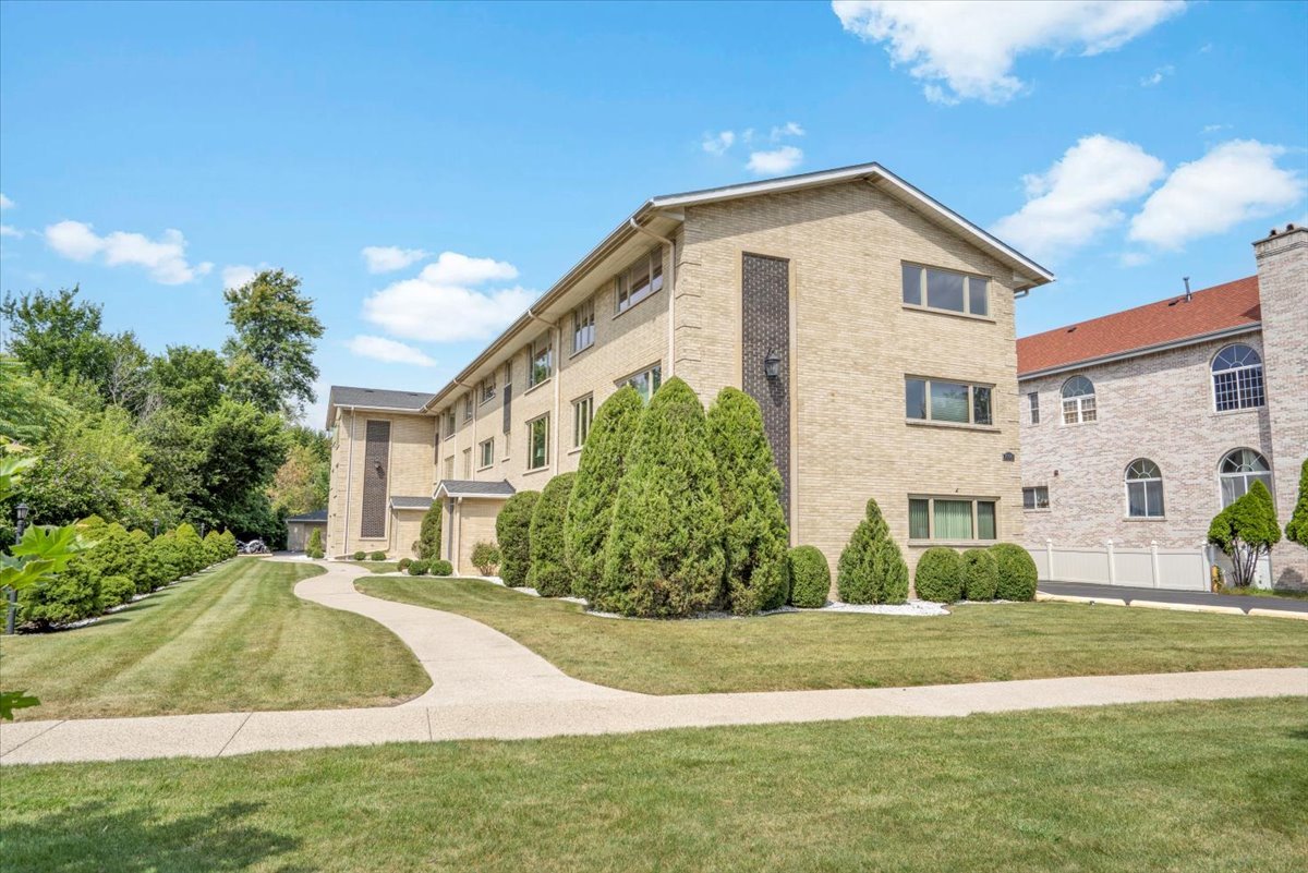 7330 Ogden Avenue, Unit 3 Riverside, IL 60546 - Photo 2 of 37 a front view of a house with a yard