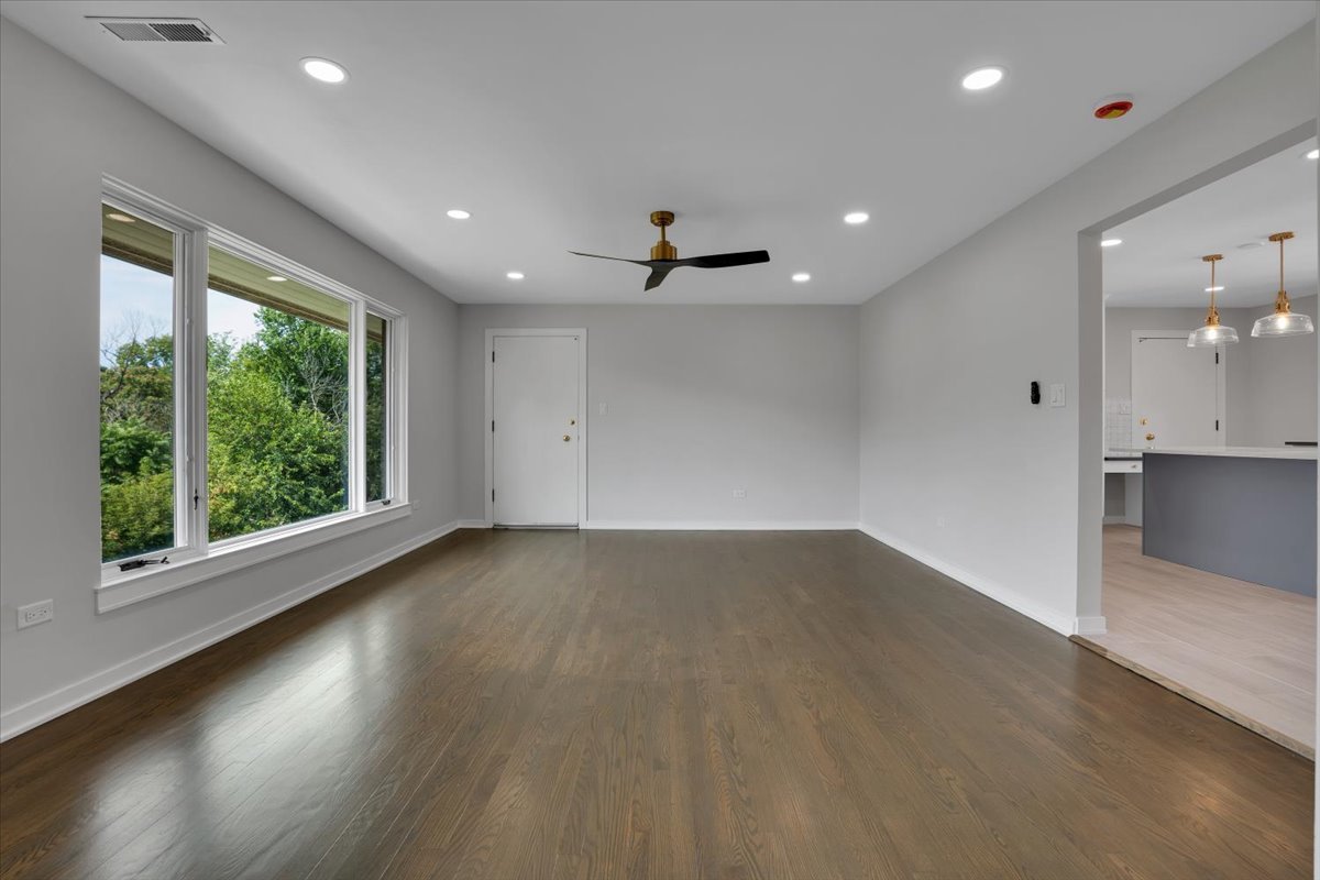 7330 Ogden Avenue, Unit 3 Riverside, IL 60546 - Photo 3 of 37 an empty room with wooden floor and windows
