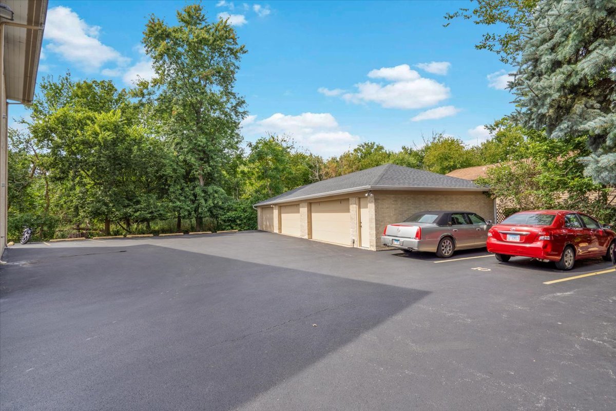 7330 Ogden Avenue, Unit 3 Riverside, IL 60546 - Photo 35 of 37 a car parked in front of a house with a garden