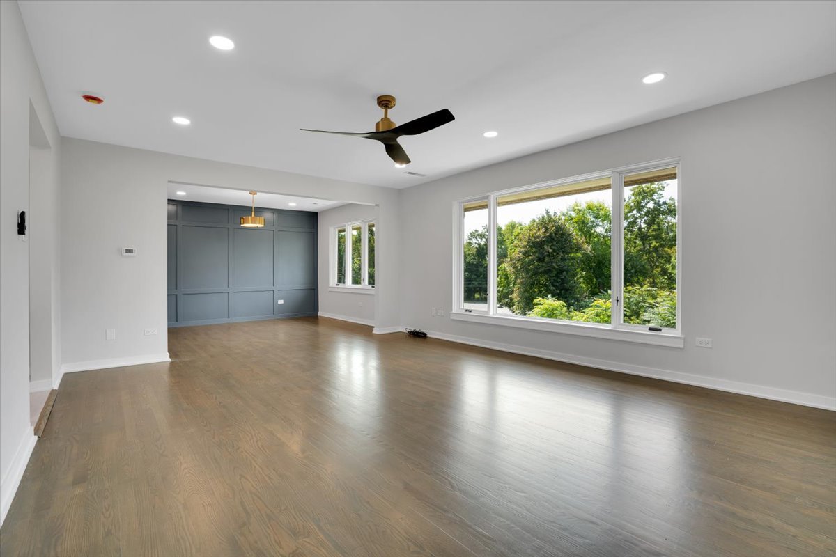 7330 Ogden Avenue, Unit 3 Riverside, IL 60546 - Photo 6 of 37 an empty room with wooden floor and windows