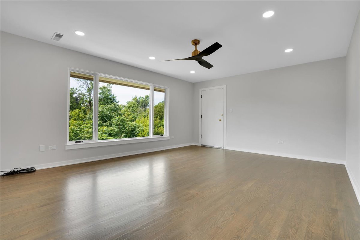 7330 Ogden Avenue, Unit 3 Riverside, IL 60546 - Photo 7 of 37 an empty room with wooden floor and windows