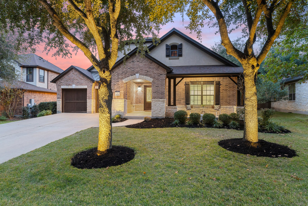 a front view of a house with a yard and garage