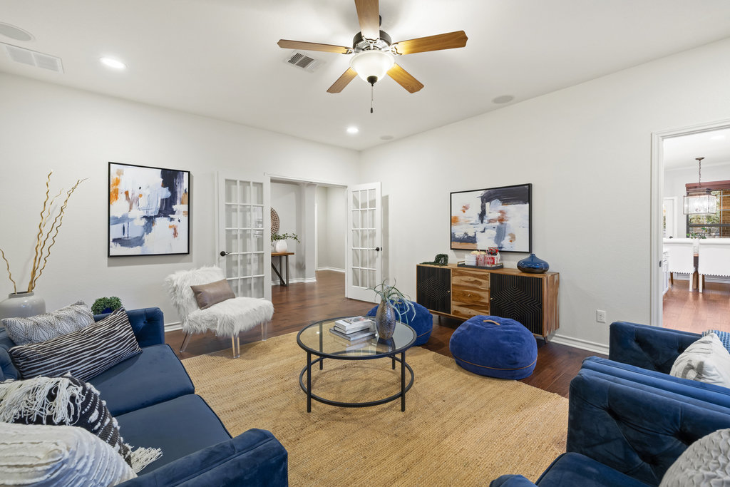11217 Bastogne Loop Austin, TX 78739 - Photo 15 of 40 a living room with furniture and a chandelier