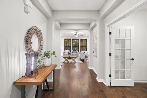 a living room with furniture and wooden floor