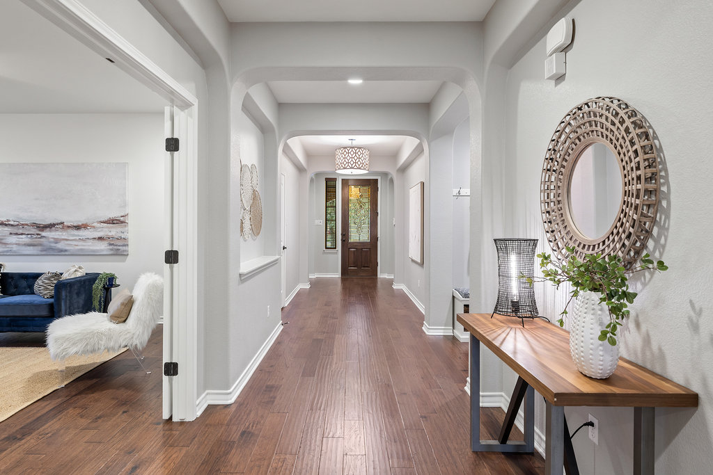 11217 Bastogne Loop Austin, TX 78739 - Photo 2 of 40 a view of a hallway with furniture and wooden floor
